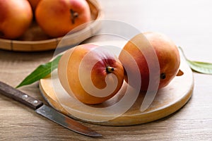 Mango fruit (Tommy Atkins) on cutting wooden board