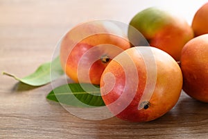 Mango fruit (Tommy Atkins) on wooden, Tropical fruit