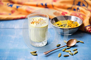 mango lassi with cardamom pods on top