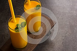 Mango Lassi Smooothie Juice with straw Overhead View