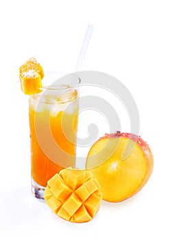 Mango and mango juice in a glass with straw