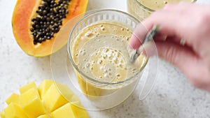 Mango papaya smoothie in glass