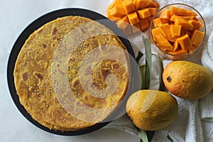 Mango Paratha. Indian flatbread made of wheat flour and mango pulp. A sweet version of Indian flatbread with fresh mangoes topped