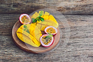 Mango and passion fruit on an old wooden background