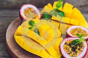 Mango and passion fruit on an old wooden background