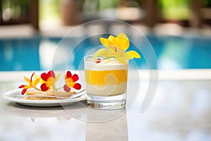 mango pudding, tropical flower garnish, poolside table