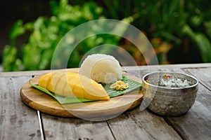 Mango sticky rice on wooden plate