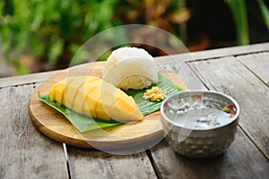 Mango sticky rice on wooden plate