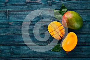 Mango. Tropical Fruits. On a wooden background.