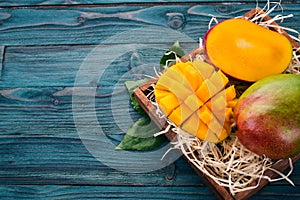 Mango. Tropical Fruits. On a wooden background.