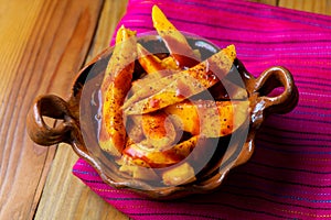 Mexican mangoes with chili powder and chamoy photo