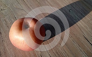 mangos fruit in green color,placed on brown wooden background