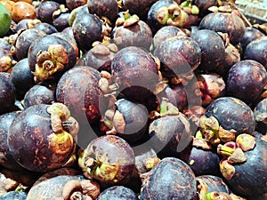 Mangosteen fruit on display for sale in a traditional market, closed