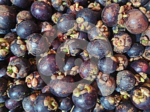 Mangosteen fruit on display for sale in a traditional market, closed