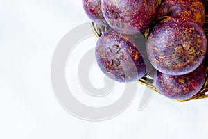 Mangosteen in traditional basket and bananas are captured isolated in top angle