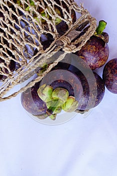 Mangosteen in traditional basket are captured isolated in top angle