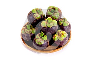 Mangosteen in wooden tray on white background. Queen of friuts