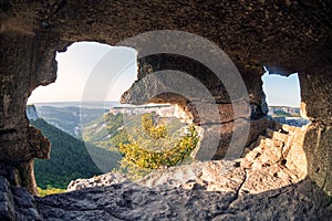 Mangup-Kale is an ancient cave town in Crimea. View from inside cave at sunset