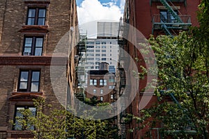 Manhattan Alley with Old Brick Skyscrapers with Fire Escapes and an Old Water Tower on the Upper West Side of New York City