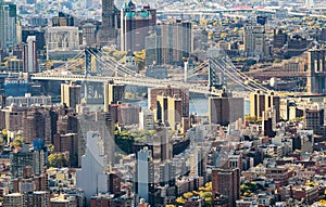 The Manhattan Bridge and Brooklyn Bridge, New York City. Aerial view from Midtown rooftop at sunset