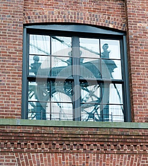 Manhattan Bridge Reflected in Brick Building Window.