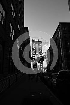 Manhattan bridge and silhouette of buildings in black and white style