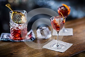 Manhattan cocktail drink decorated on bar counter in pub or rest