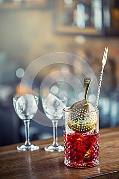Manhattan cocktail drink decorated on bar counter in pub or rest