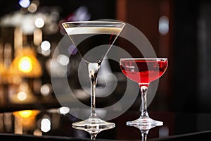 Manhattan and espresso cocktails in elegant glasses at colorful