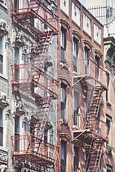 Manhattan old residential buildings with fire escapes, New York