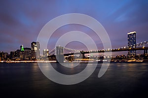 Manhattan skyline and Brooklyn bridge in New York at night