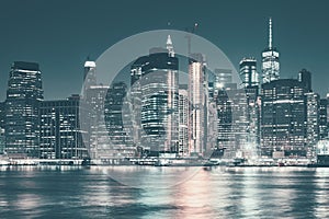 Manhattan skyline at night, color toned panorama, New York City, USA