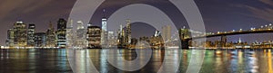 Manhattan skyline at night, New York City panoramic picture.