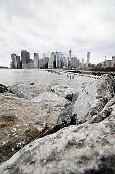 Manhattan skyline from rocky beach