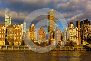 Manhattan skyline at sunrise as seen from Roosevelt Island in New York, USA.