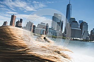 Manhattan skyline view from a high speed boat, over blonde woman