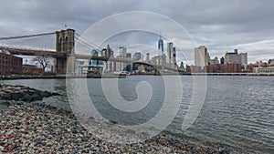 Manhattan skyline viewed from Brooklyn with Brooklyn bridge, in New York City, USA