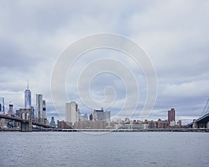 Manhattan skyline viewed from Brooklyn with Brooklyn bridge, in New York City, USA