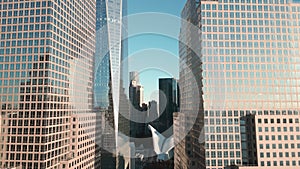 Manhattan view from above. Forwards fly above street between modern buildings. Day in Manhattan, NYC aerial view. New