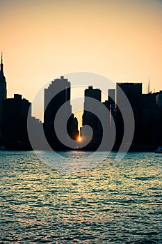 Manhattanhenge New York City skyline seen at sunset with sunlight