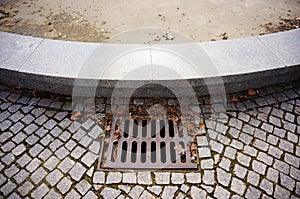 Manhole on a cobblestone in the street during daytime