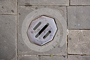 Manhole Cover On Cobbled Road