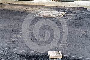 Manhole cover with new asphalt