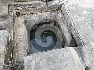 Manhole cover open in street and repair of roads. Accident with sewer hatch in city. Concept of sewage, underground utilities