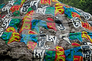 Mani colour Stones with Buddhist mantra Om mani padme hum in Himalaya Nepal
