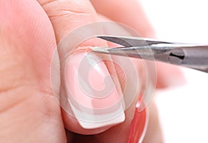 Manicure applying - cutting the cuticle photo