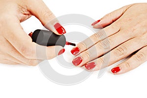 Manicure. Applying red nail polish