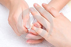 Manicure applying - wiping the moisturizer
