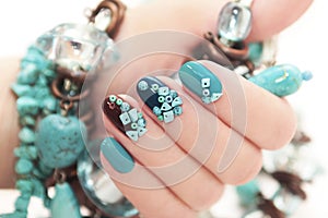 Manicure with beads and turquoise. photo