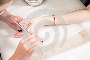 Manicure beauty salon. manicurist makes the procedure for the care of nails